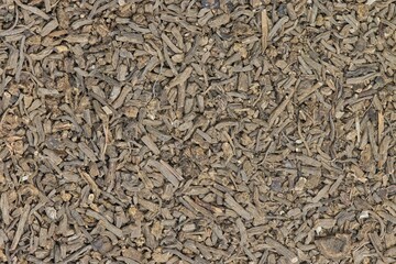 Dried Valerian root pieces (Valeriana officinalis), closeup background image. Traditional medicinal herb also used as a cat attractant.	