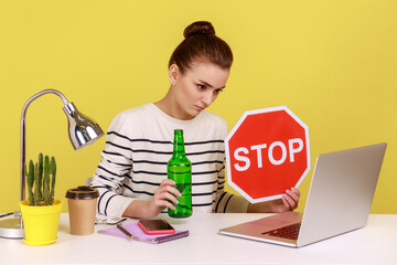 Woman office worker in striped shirt sitting on workplace and having video conference, showing...