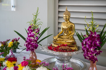 Buddha statue and flower garlands for Buddha bathing ceremony on important religious days for Buddhists.