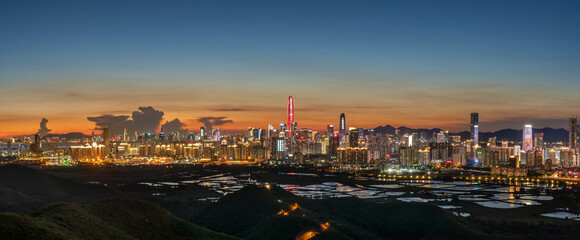 Panorama of skyline of Shenzhen city, China at sunset. Viewed from Hong Kong border