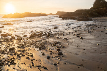 warm sunset over receding tide of the pacific ocean
