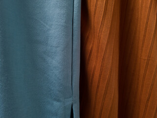 Abstract cloth background with orange and light blue textures exposed to sunlight so that shadows are formed