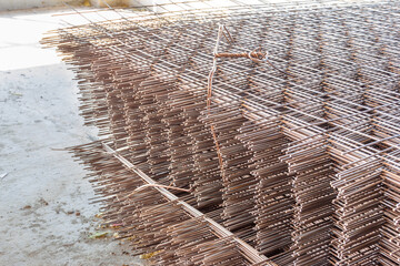 rusty new reinforcing mesh made of thin corrugated steel bar stacked in several pallets