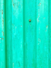 Turquoise painted metal wall with corrosion. Striped panels. Rusty screw. Old invoice. Backgrounds.