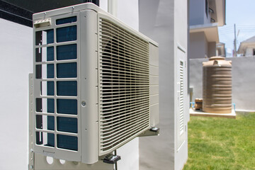 Air conditioner compressor outdoor unit installed on a facade of the house