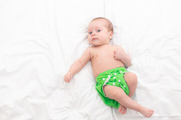 Reusable diaper on the baby copy space . An article about reusable diapers. Saving on diapers....