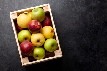 Colorful ripe apple fruits in box
