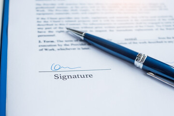 signature with pen on contract documents. Contract agreement, approve, law and deal concepts