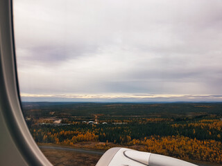 Northern Finland landscape in autumn colors seen from an airplane window.