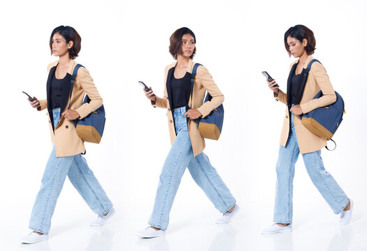 Full length of Asian Indian 20s working woman with curl hair hold cell smart phone backpack blazzer