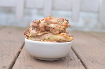 grilled chicken on a white platter outdoors