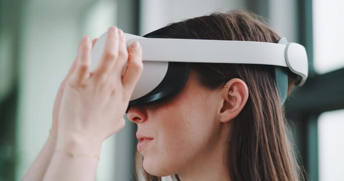 Side view of young woman putting on virtual reality headset