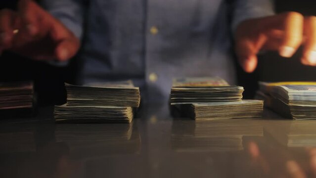 Businessman shows stack of dollars. Bills in the strap. Success man showing a pile of money.