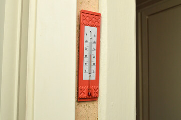 Room thermometer shows a temperature of about 25 degrees
