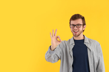 Concept of people, young man on yellow background
