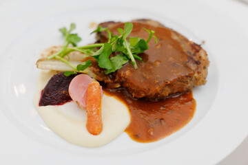 Grilled sliced beef steak with green salad on a plate.
