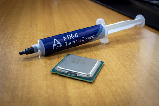 Sochi, Russia - May 10 2022: Thermal interface material paste MX-4 in syringe for cpu cooling and Intel cpu near it.