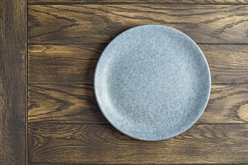 Empty bluish plate on oak wooden table.Top view, with copy space - 506568036