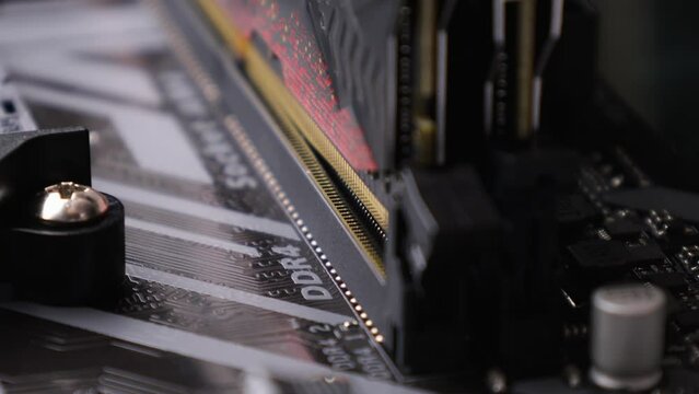 A random-access memory (RAM) installs in the socket on motherboard. PC hardware
