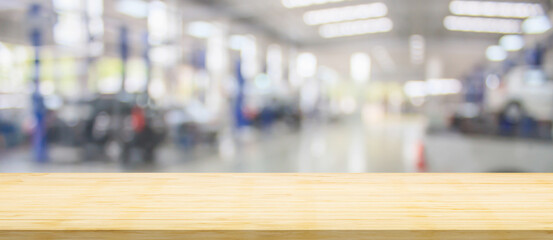 Empty wood table top with car service centre auto repair workshop blurred background