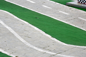 A fragment of an empty children's race track on a spring morning