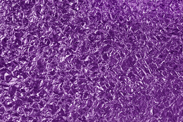 Purple metallic foil shiny texture, wrinkled wrapping paper for background and design art work.