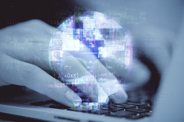 Close up of hands using laptop computer keyboard with human skull hologram. Web danger, hacking and...