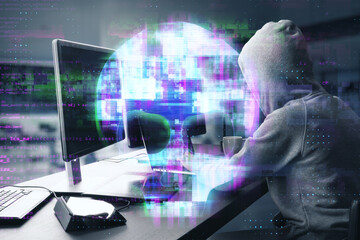 hacker at desktop using laptop computer keyboard with abstract digital skull hologram on blurry...