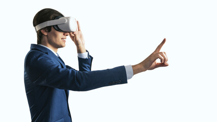 Young businessman working in virtual reality office in VR glasses, presses his finger virtual interface on abstract white backdrop. Innovate and future technology concept, close up