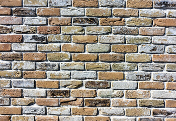 Ancient handmade brick wall of various colors