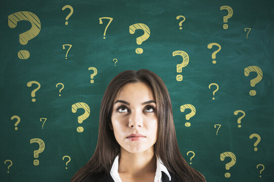 Best decision and find solution concept with pensive woman on green chalkboard backdrop with golden color question marks