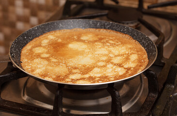 Pancakes from liquid dough are fried