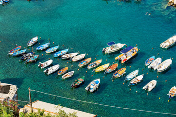 Aerial view of a group of small boats moored in the port of the ancient Vernazza village, Cinque...