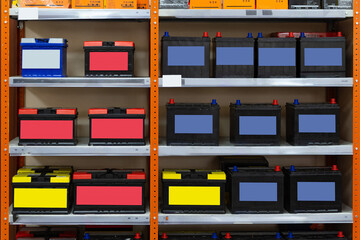 Car batteries on shelves, racks of auto parts store. Sale, maintenance and repair of auto...