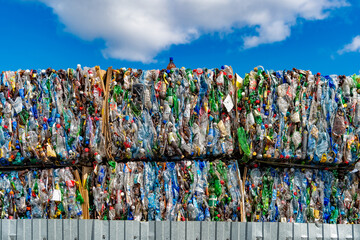 Plastic bottles in bales ready for recycling. Sale, collection of plastic waste, environmental...