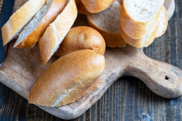 wheat baguette cut into pieces on a cutting board