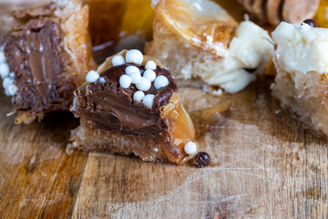 decorated dessert of sweet puff pastry with chocolate filling and natural honey