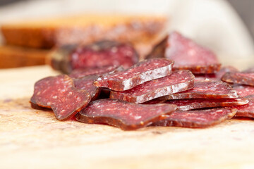 sliced piece of cured sausage on the table