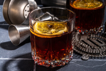 Hard alcohol drink with orange slice garnish. Negroni cocktail with dried orange and whiskey, copy space