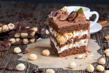 a piece of cake made of chocolate sponge cake cream and caramel with hazelnuts