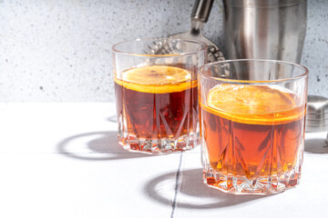 Hard alcohol drink with orange slice garnish. Negroni cocktail with dried orange and whiskey, copy space