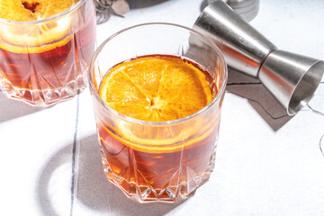 Hard alcohol drink with orange slice garnish. Negroni cocktail with dried orange and whiskey, copy space