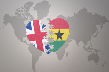 puzzle heart with the national flag of ghana and great britain on a world map background. Concept. - obrazy, fototapety, plakaty