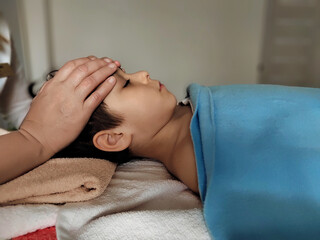 osteopath does physiological and emotional therapy for kid. pediatric osteopathy treatment session. alternative medicine. taking care of the child's health.