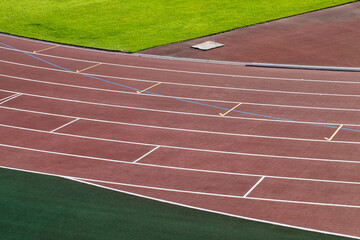 Obraz premium the red surface of the old running track at the stadium