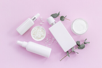 Flatlay of thite tube and bottle for cosmetic products, top view