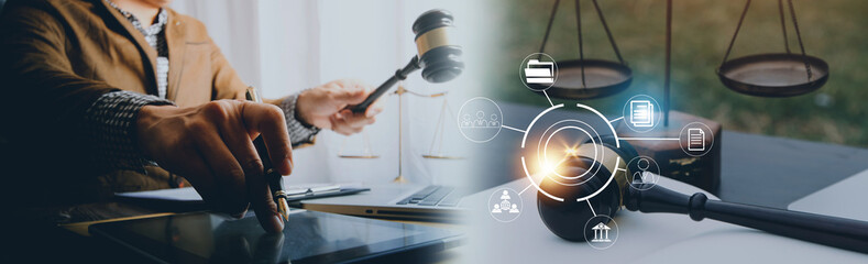 Justice and law concept.Male judge in a courtroom with the gavel, working with, computer and docking keyboard, eyeglasses, on table in morning light
