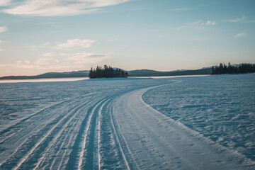 Cross country ski track leading towards the horizon on Lake Storsjö close to swedish Ljungdalen on the ice during winter. Copy space included.