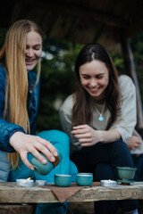 Girls in the woods pours Chinese tea. Tea ceremony in the woods