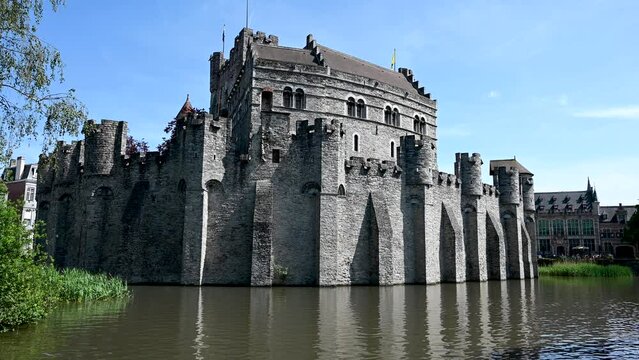 Ghent, Belgium: Castle by river canal in city centre. Fortified towers and walls on medieval fortification. Gravensteen castle.